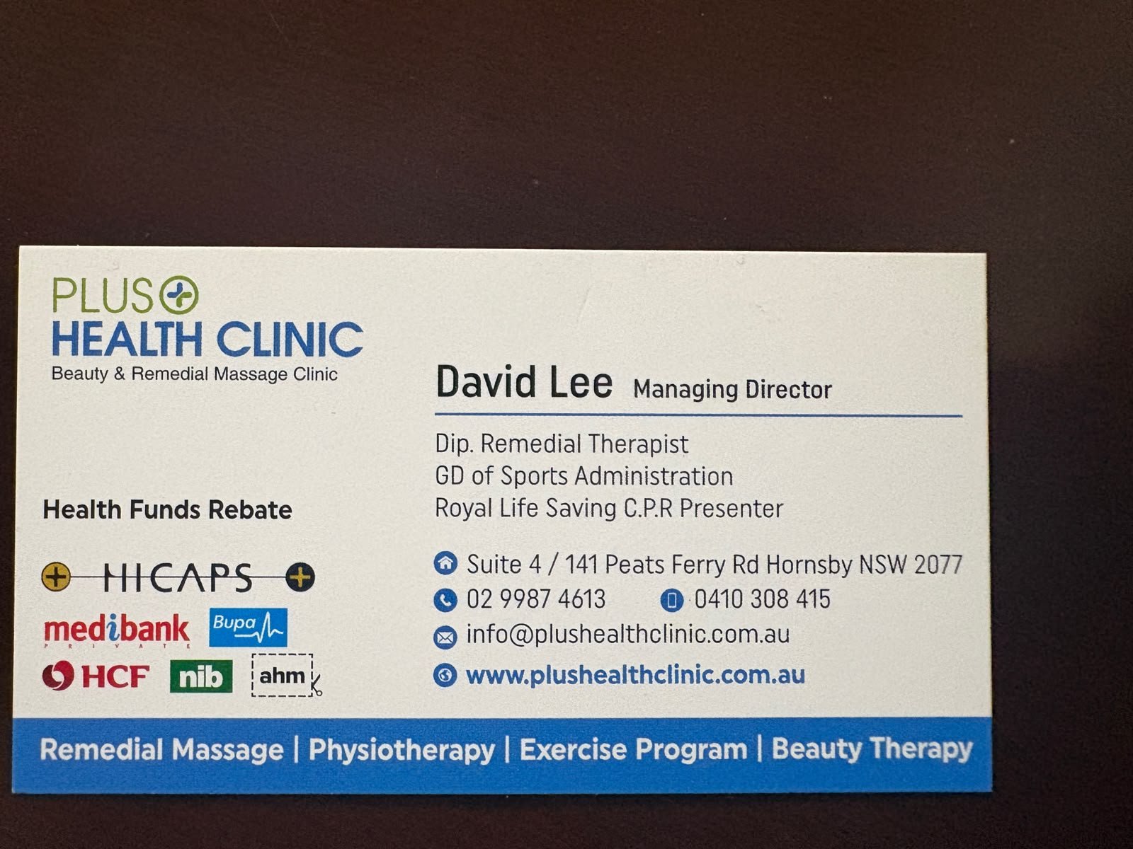 Plus Health Clinic business card showing health fund information